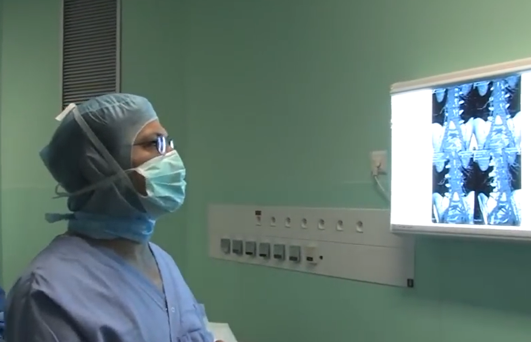 Neurosurgeon in the operating room viewing medical images